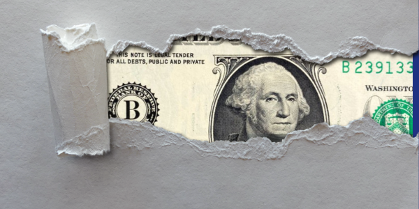 Dollar Bill behind ripped paper